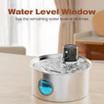 Load image into Gallery viewer, A stainless steel water fountain with a sensor, featuring a water level window and a small water dispenser on top, placed on a table.