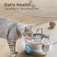 Load image into Gallery viewer, Cat drinking water from a stainless steel pet fountain on a wooden floor.