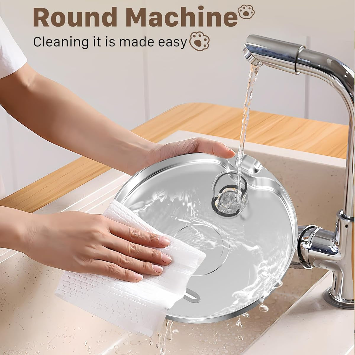 Round machine component being cleaned with water and a cloth in a sink.