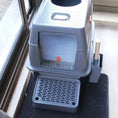 Load image into Gallery viewer, Cat standing on a black mat next to a gray litter box.