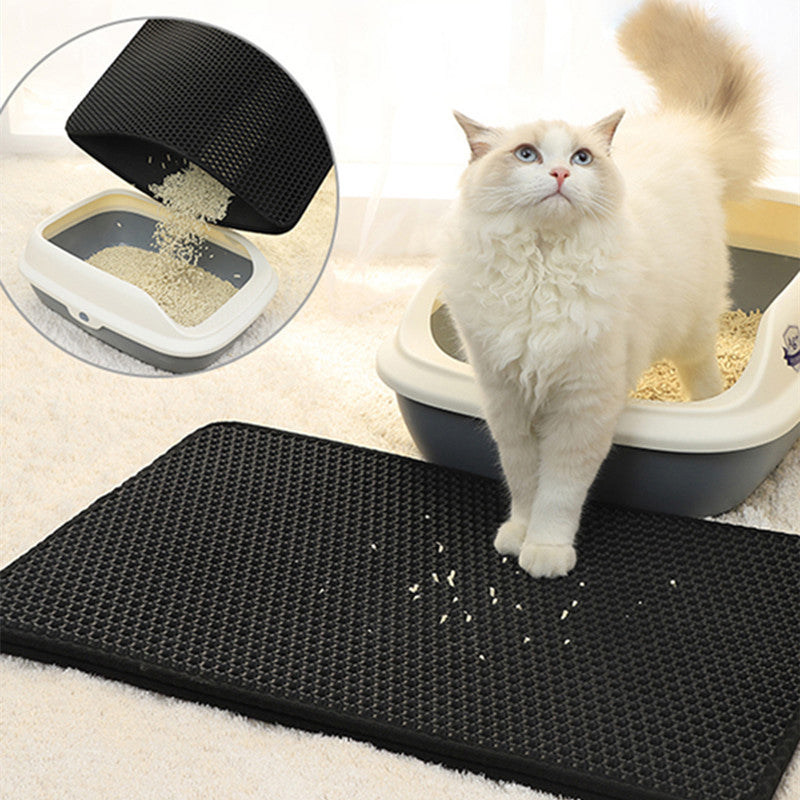 A black double-layer honeycomb cat litter mat with a white cat sitting on it, with the litter box shown in the inset image indicating the mat's purpose and use.