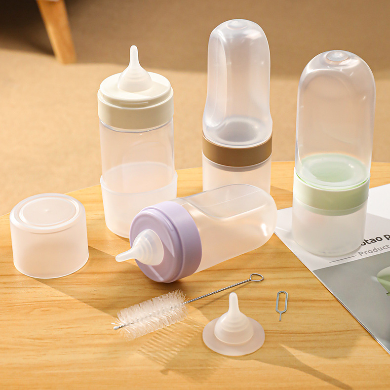 Set of pet bottles with accessories on a wooden surface