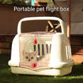 Load image into Gallery viewer, A white plastic pet carrier with a skylight, ventilation window, and a cat looking out from the inside. The carrier is placed on a grassy surface with a bright, clear environment.
